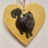 Black fluffy tail on gold - ornament