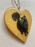 Black fluffy tail on gold - ornament